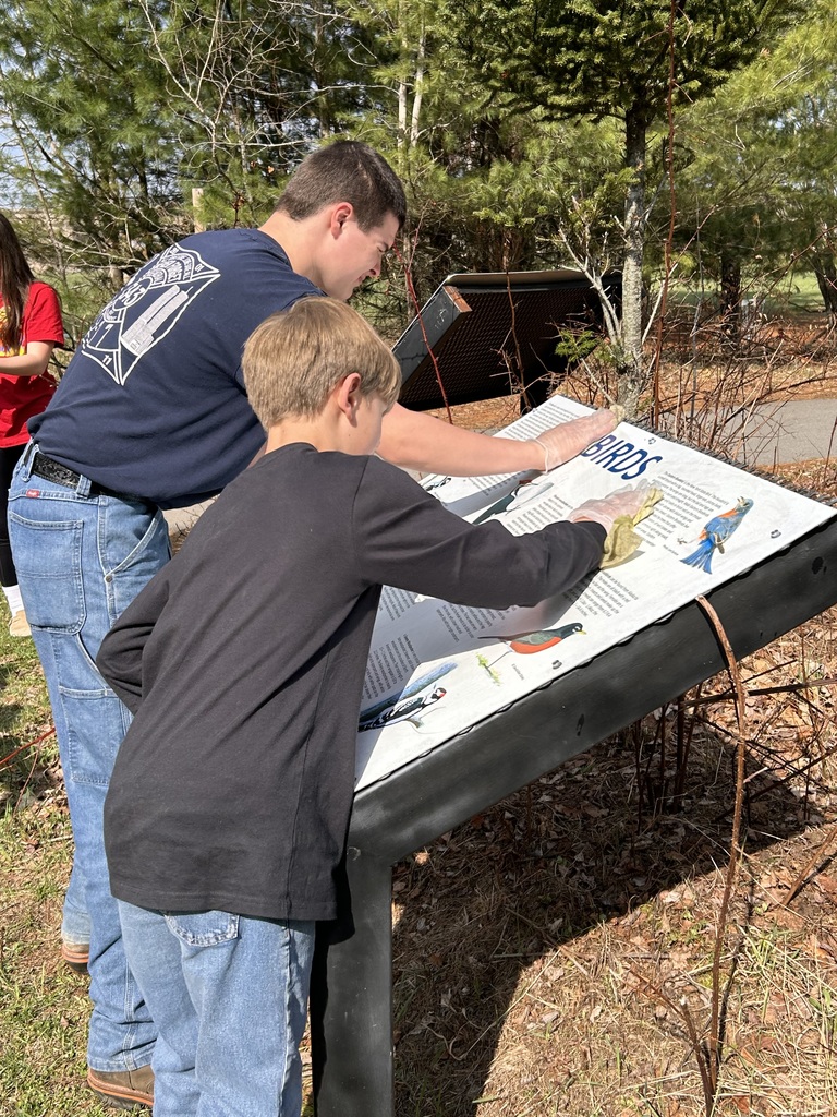 Two students washing a sign