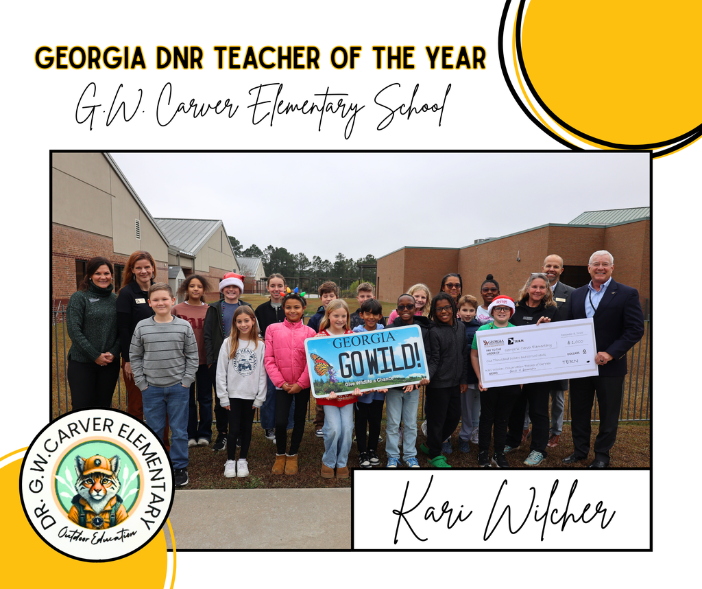 Georgia DNR Teacher of the Year with students holding a Go Wild sign and a $1000 check from DNR