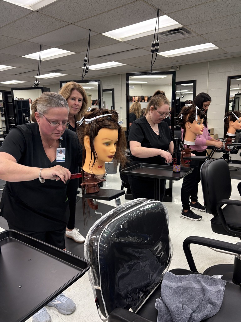 Learning how to cut hair in Cosmetology class.