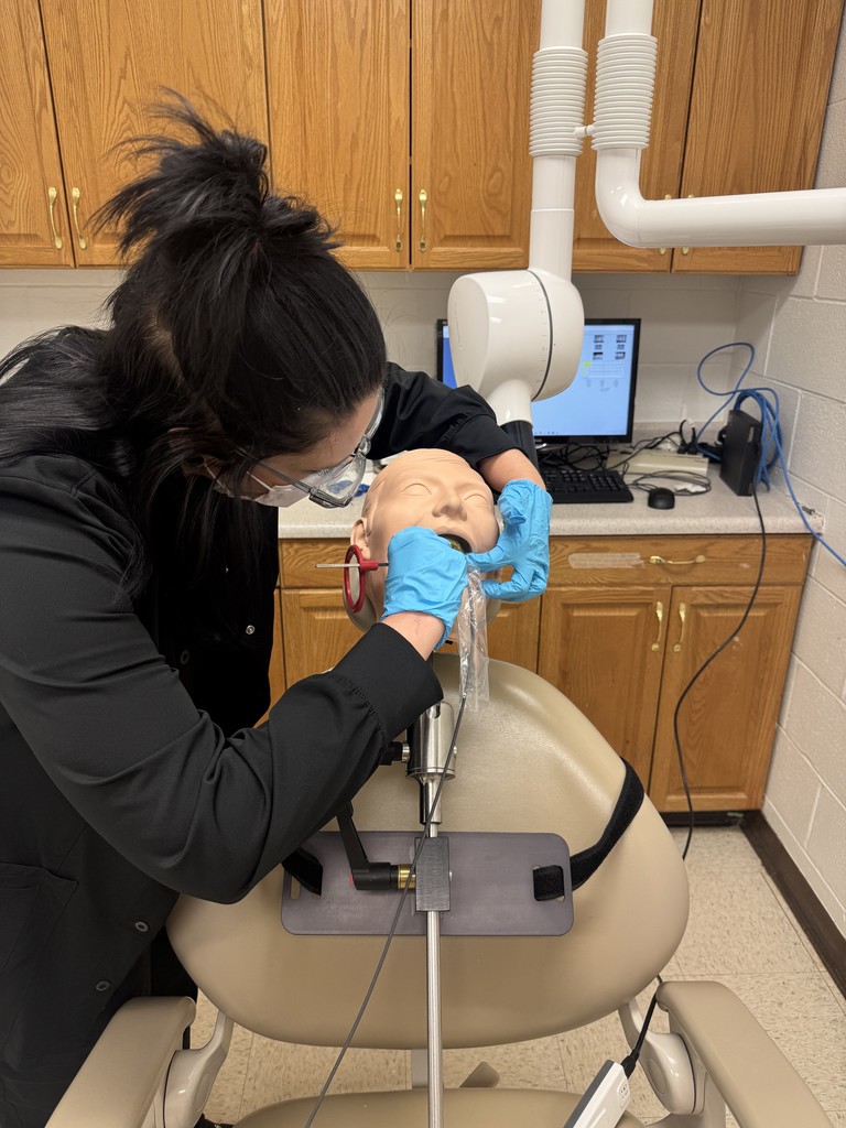 Dental Assisting students using  a X-ray machine. 