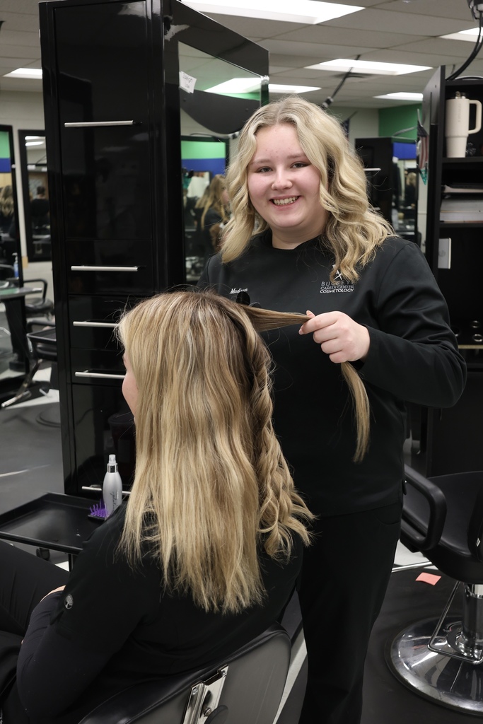 Cosmetology students working with hair
