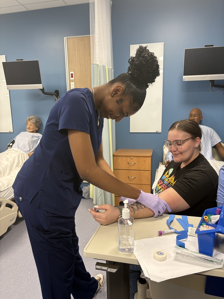 Adult Education Phlebotomy students  are practicing venipuncture on volunteers.