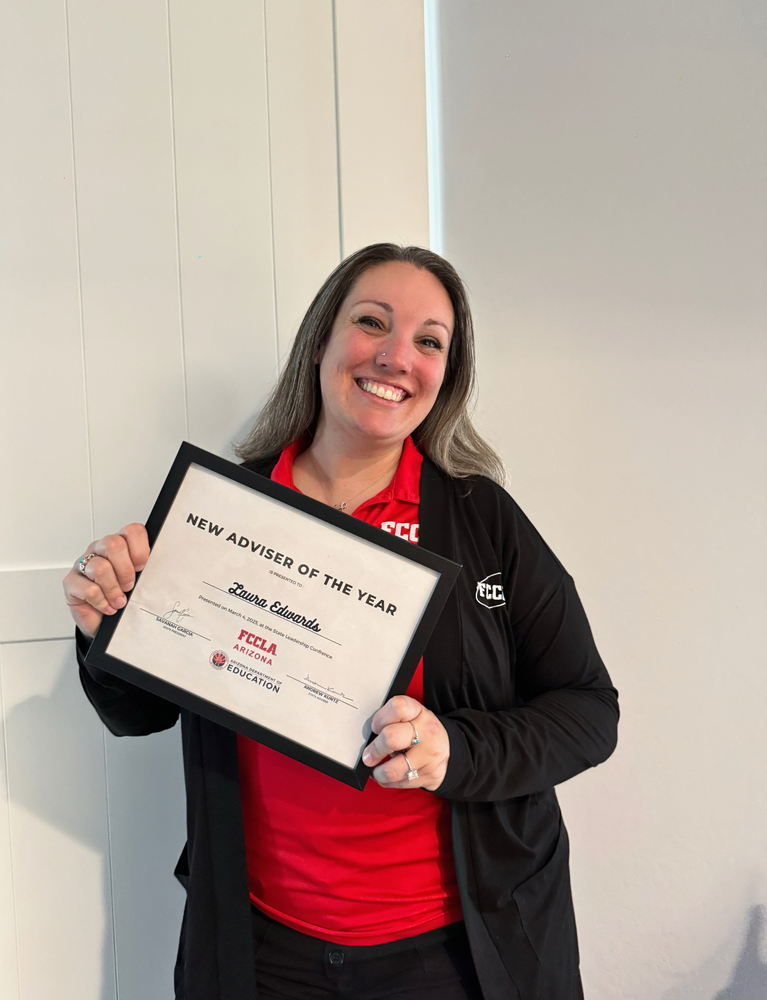 Mrs. Edwards holding her award for "New Adviser of the Year"