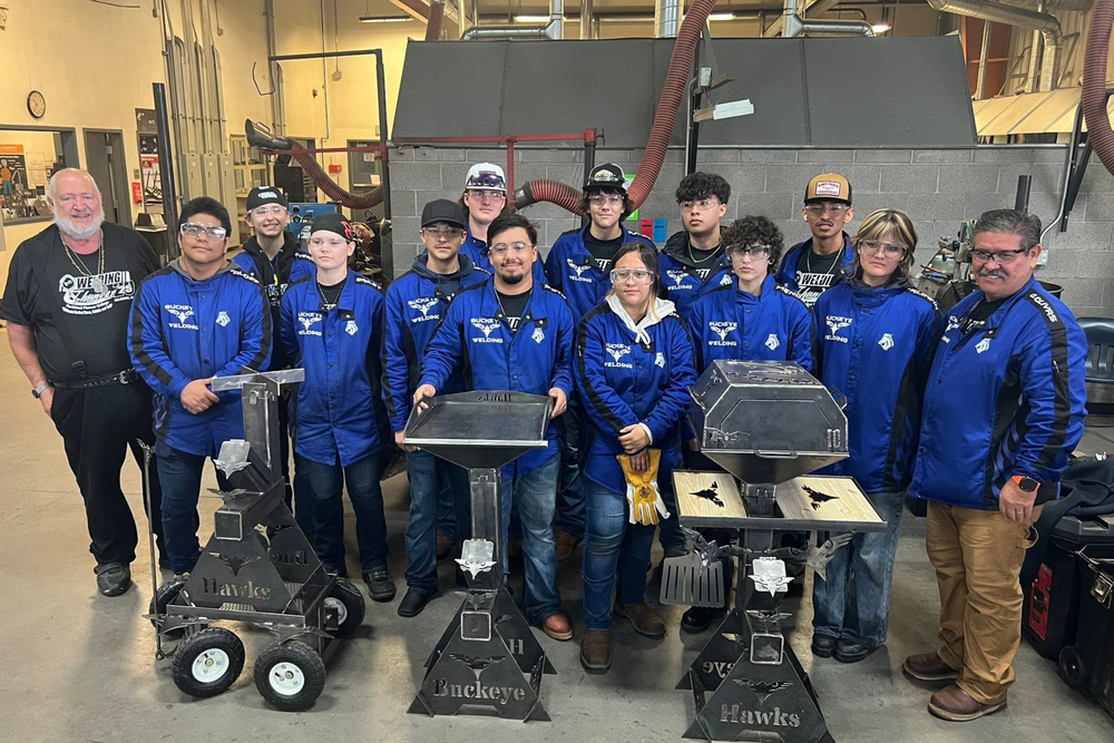 A group of BUHS participants poses behind their completed welding projects at the 2025 Welding Thunder fabrication competition.