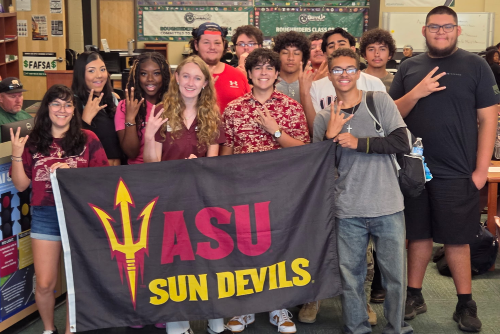students posing with a flag