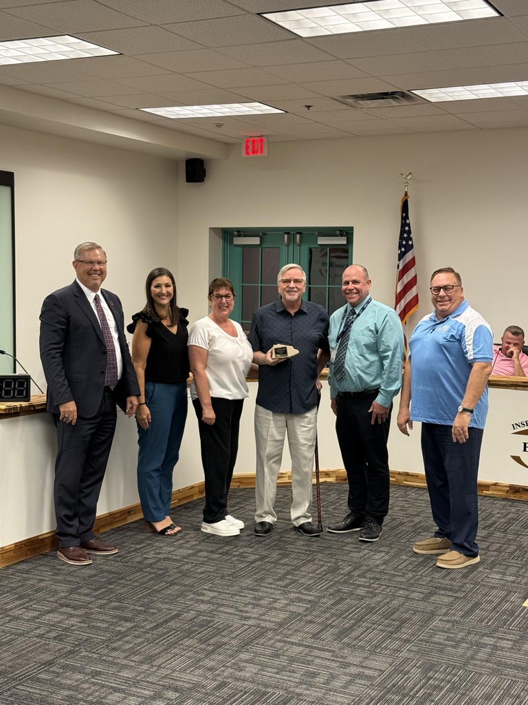 photo of Dave Sousa posing with his rock award. 