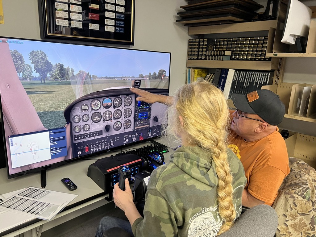 students utilizing flight simulator