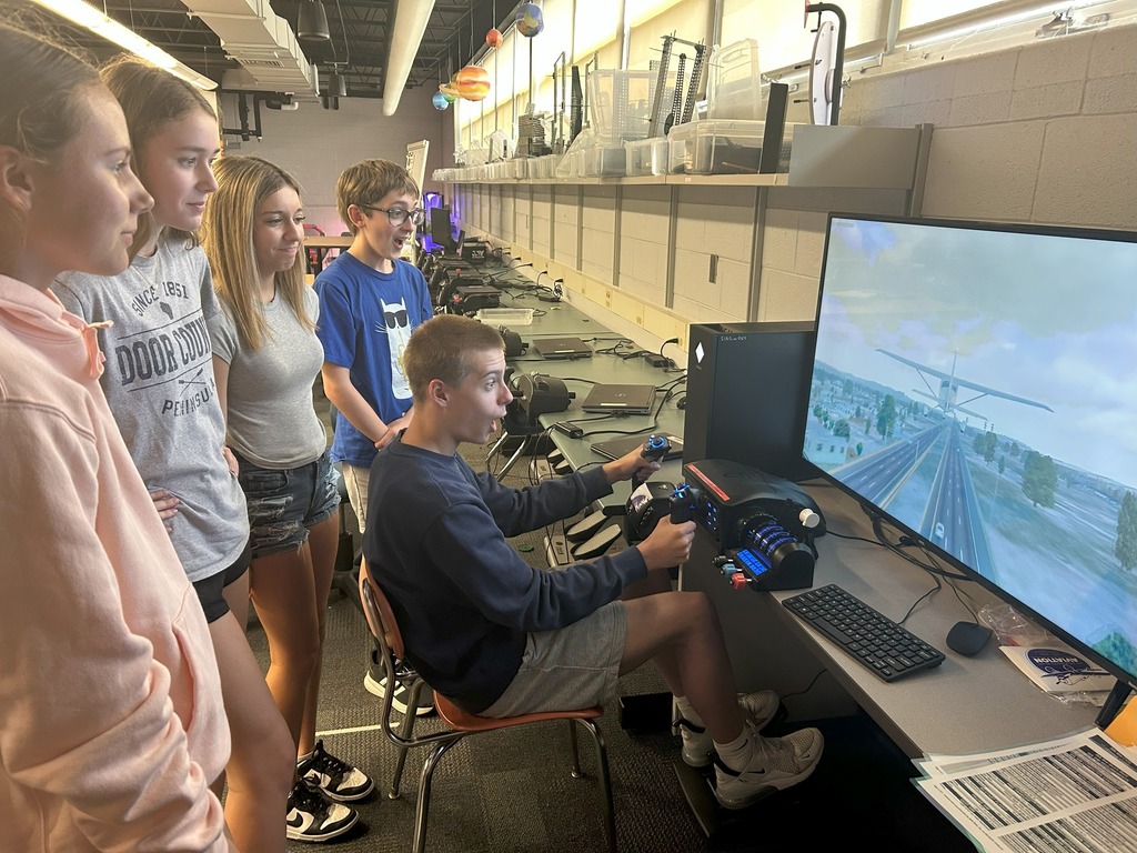 students utilizing flight simulator