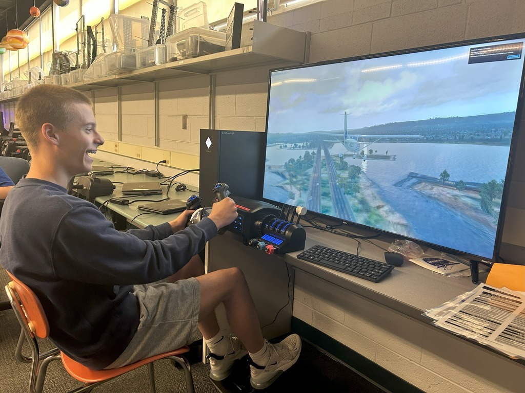 students utilizing flight simulator