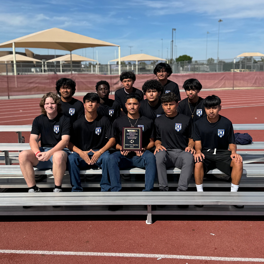 boys posing with awards