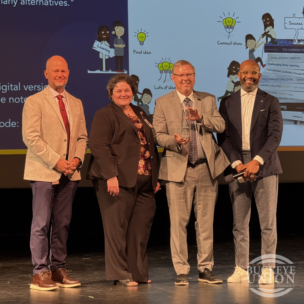 admin posing with award