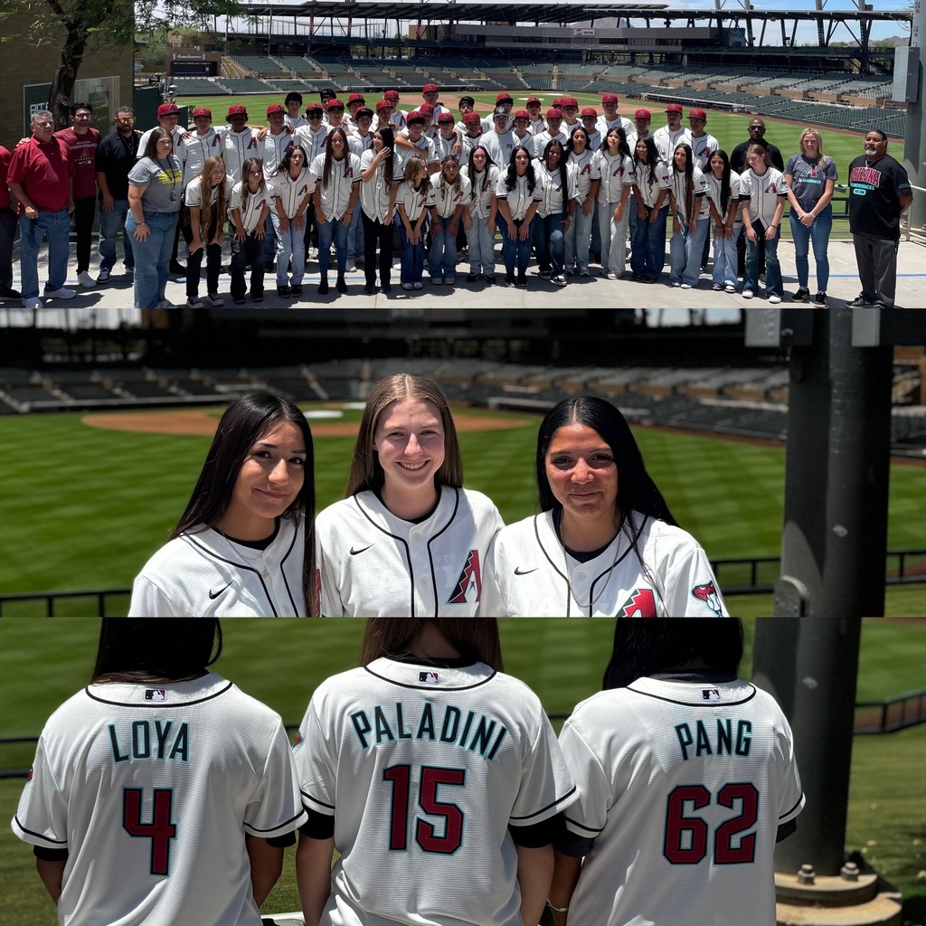Group of people in sports uniforms on a baseball field. Three women stand side by side, facing back.