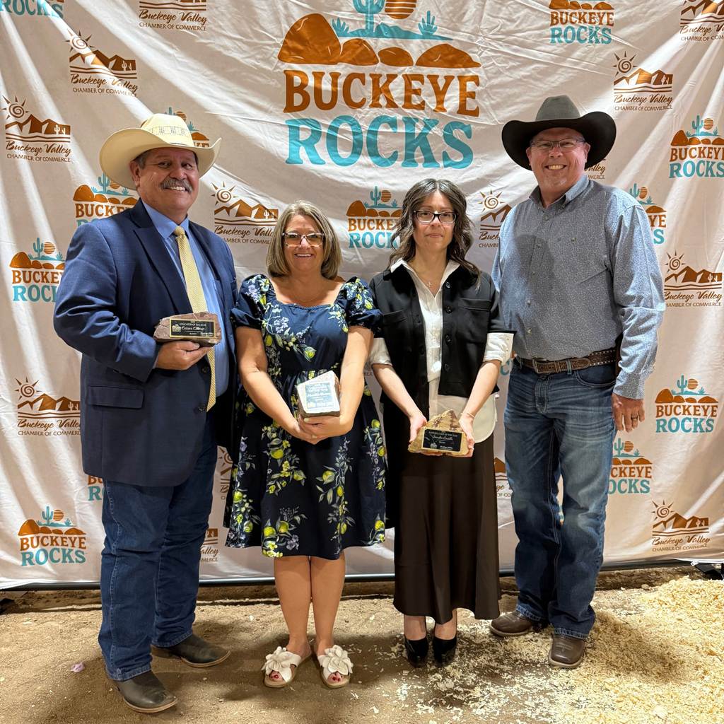 group of people standing together and smiling for photo - three of them are holding awards