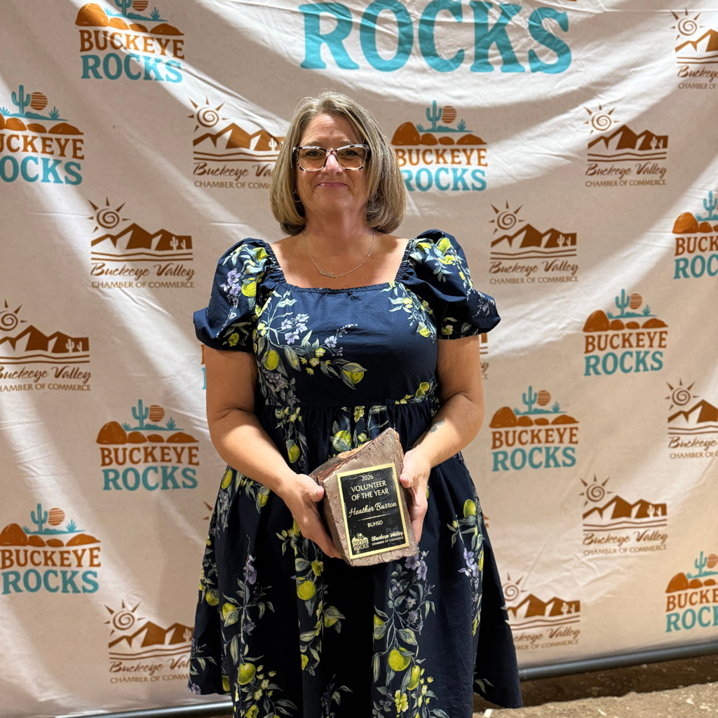 woman smiling and holding an award