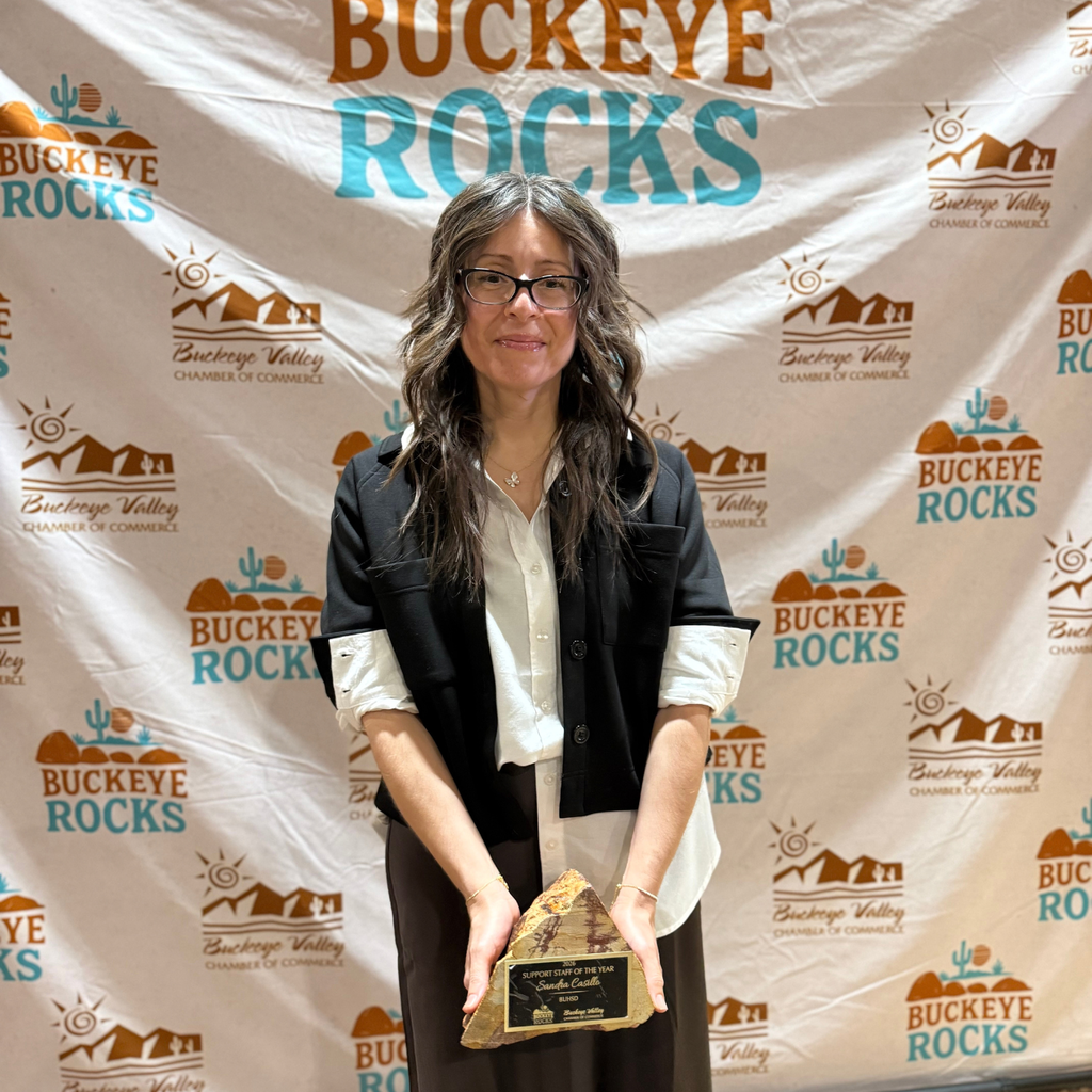 woman smiling and holding an award