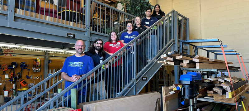 Several people standing on a staircase and smiling.