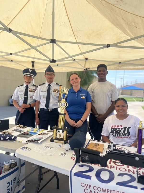 Students sitting and standing at JROTC table