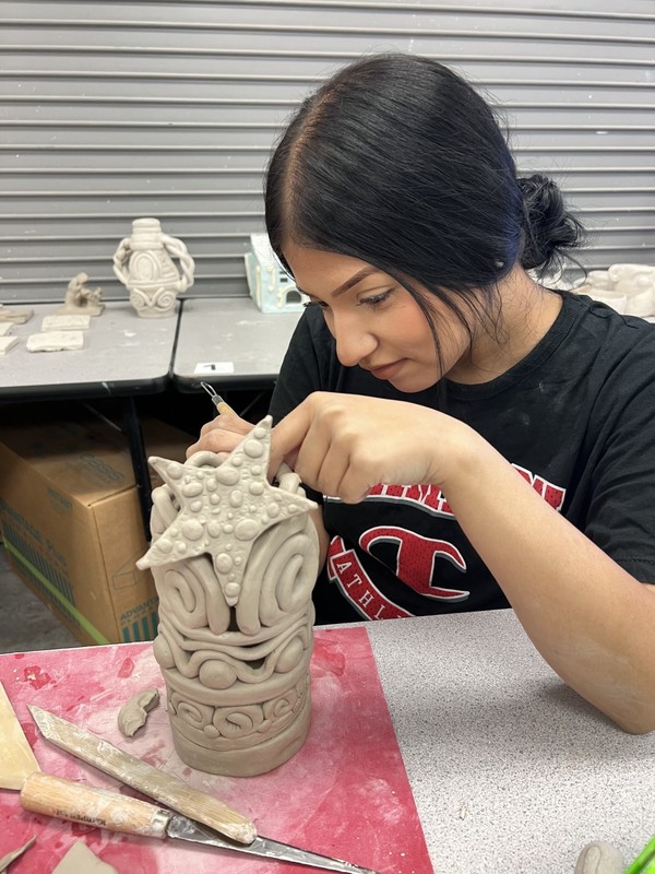Student working on ceramics piece