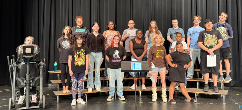 Unified Choir rehearsing on stage