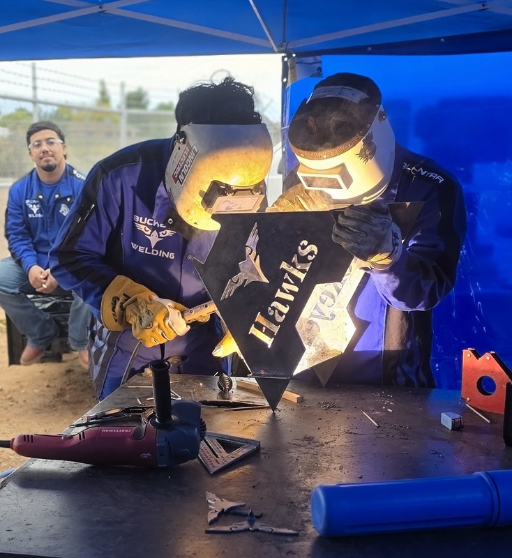 two student welders welding