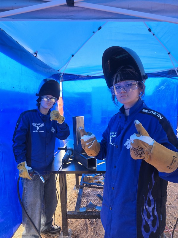student welders posing