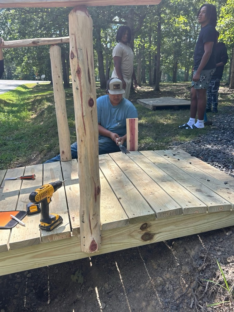 Carpentry class building a bridge