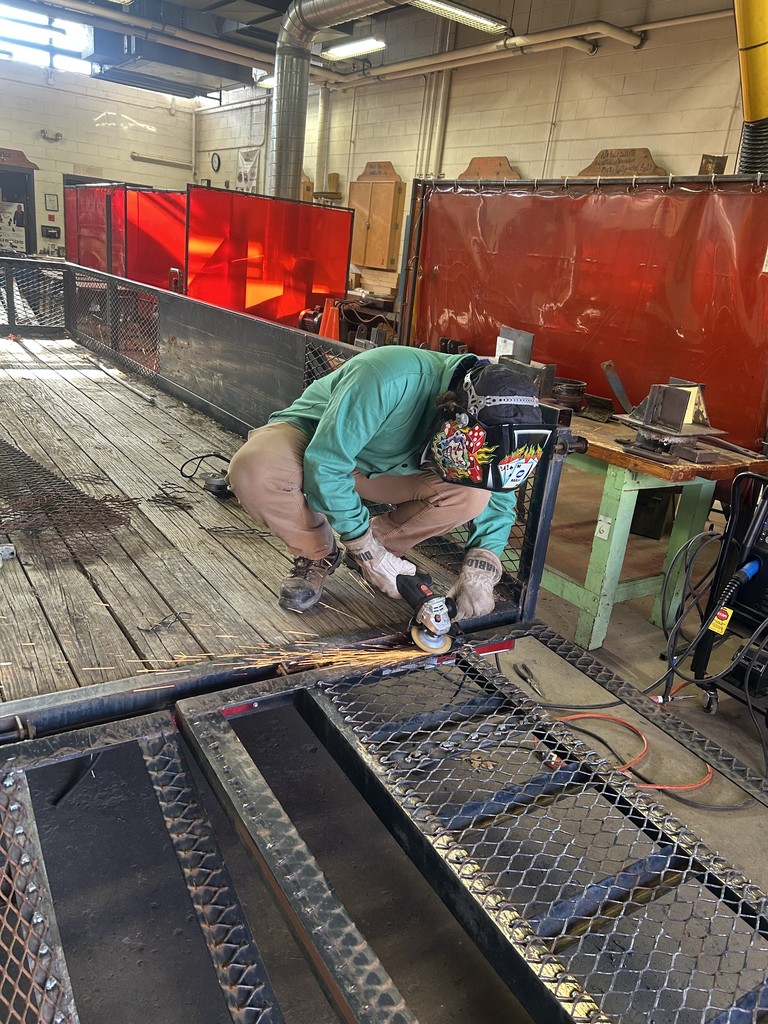 Welding working on Grounds Crew's trailer