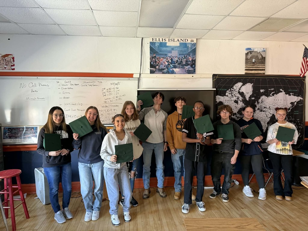 Seniors in the classroom with their newly received graduation caps