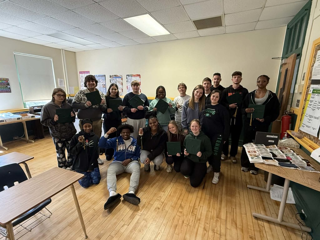 A classroom full of seniors with their newly received graduation caps