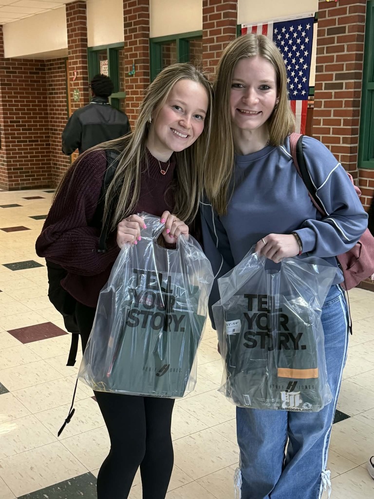 Two seniors with their senior cap, gown, and swag.