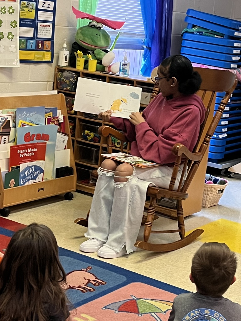 BCHS FFA Member reads to  preschoolers