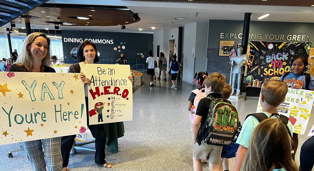 BE Principal and Staff welcome students with smiles and signs reminding them Attendance is important