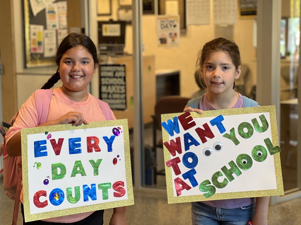 BE students pose with posters that every day counts and we want to see you at school