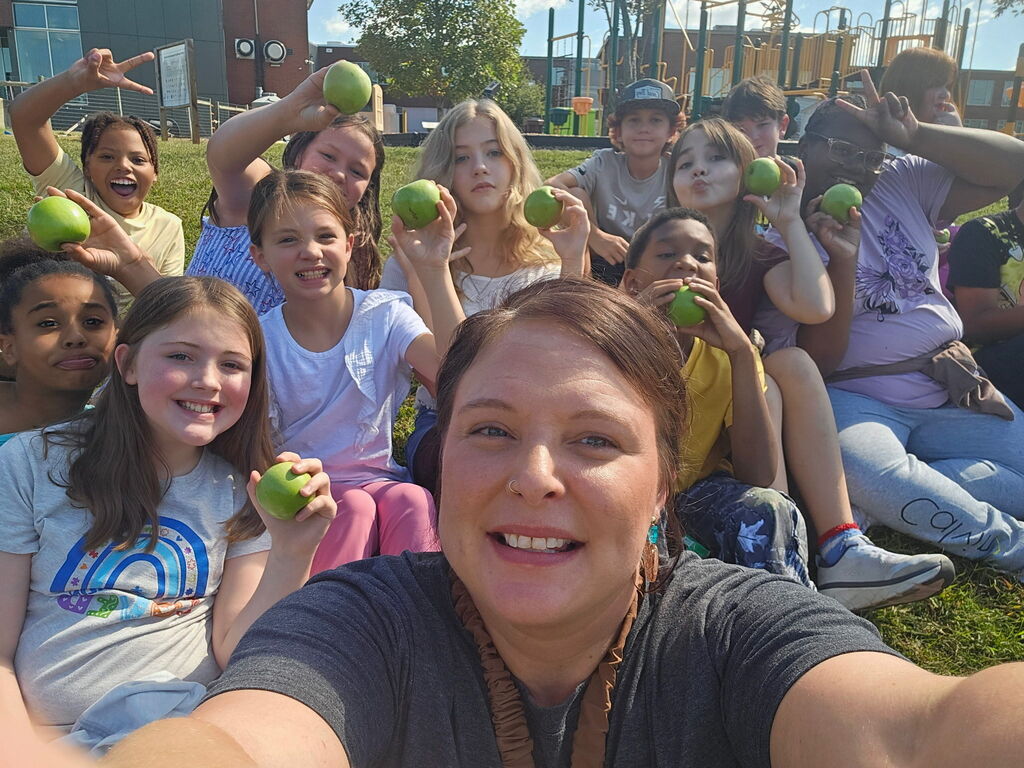 Mrs. Gates with her students and her apples.