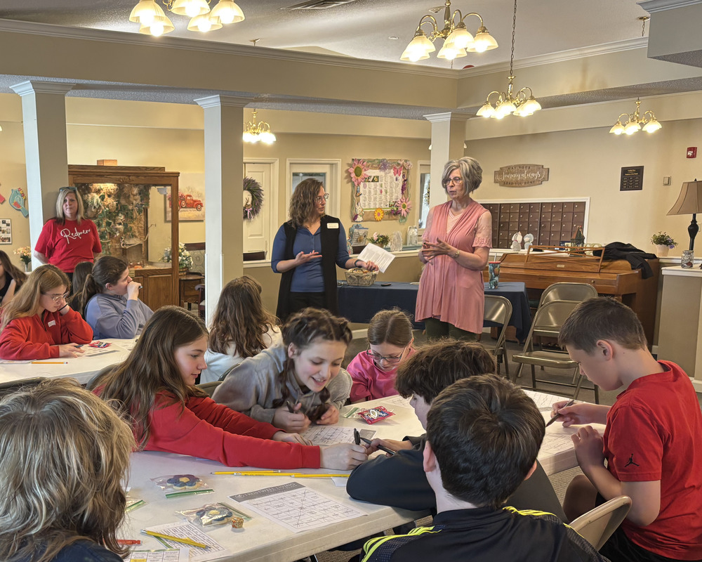 Becky Lutz of the Crawford County Chamber of Commerce looks on as Trustwell Living’s Community Relations Director, Carmen Walters engaged students with Aging-care Career BINGO!
