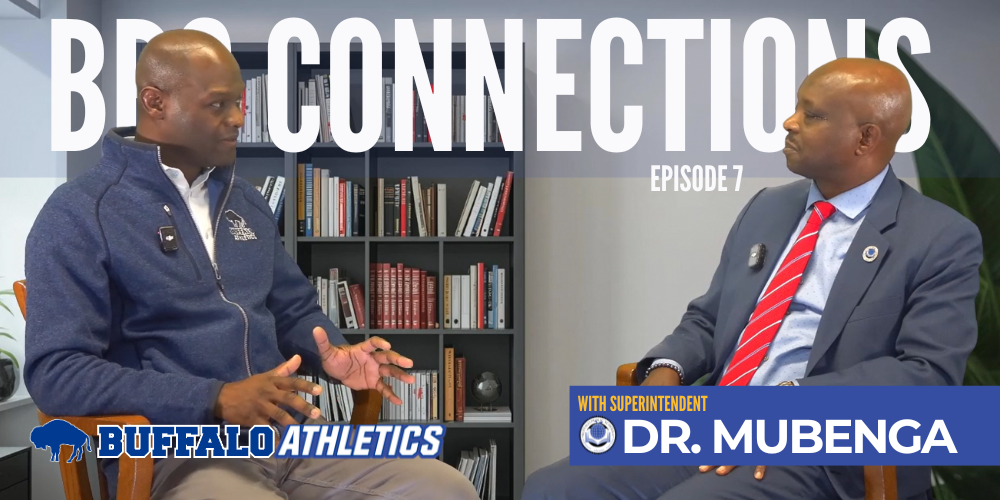 Superintendent Mubenga sits with Athletic Director Aubrey Lloyd to explain that, at the modified level, students can expect a focus on skill development, teamwork, confidence building, and learning the fundamentals of organized sports in a supportive, fun environment that meets athletes where they are.
