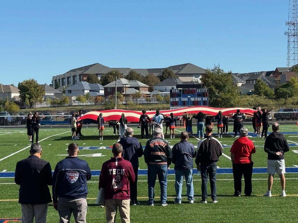 People holding American Flag on Field 