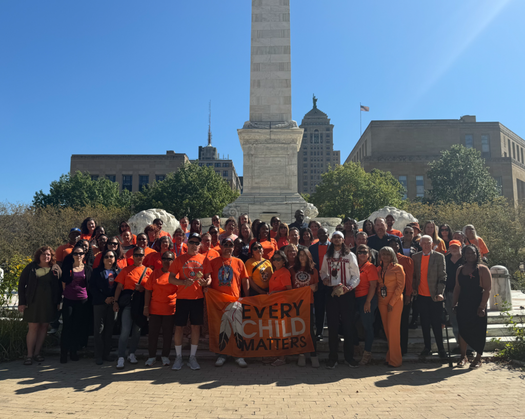 Group of people wearing orange shirts outside
