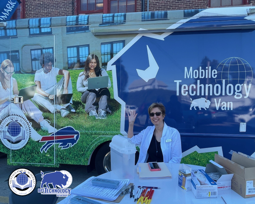A nurse outside the BPS Tech Van waving