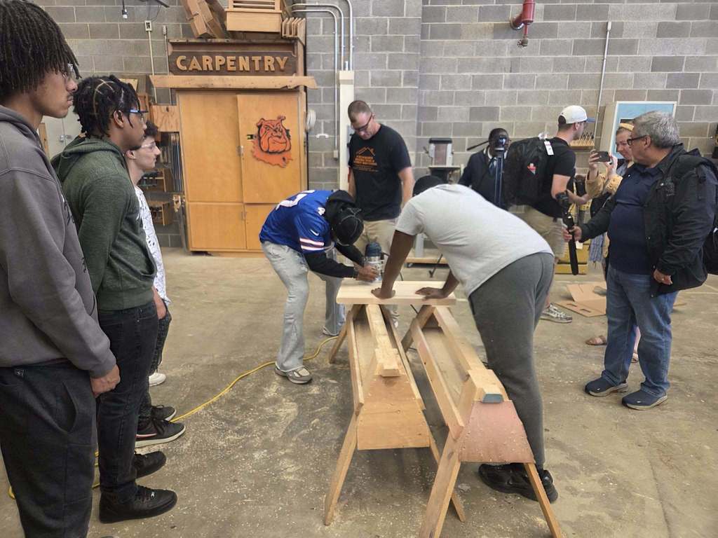 Buffalo Bills working on carpentry with a student