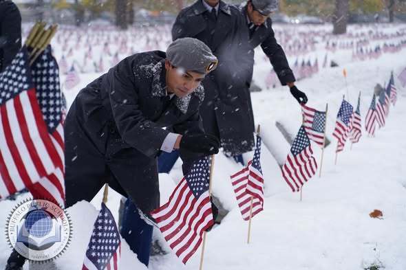 JROTC Students Paying Respects with American Flags at Soligers Cemetary