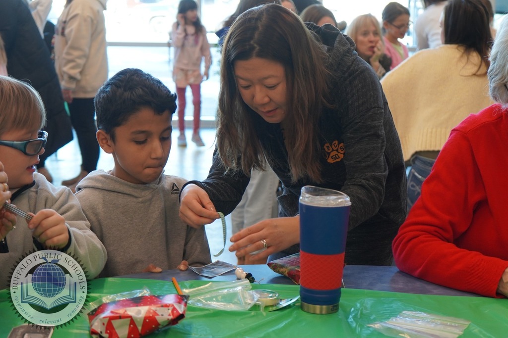 Teacher making Chirstmas crafts with a student