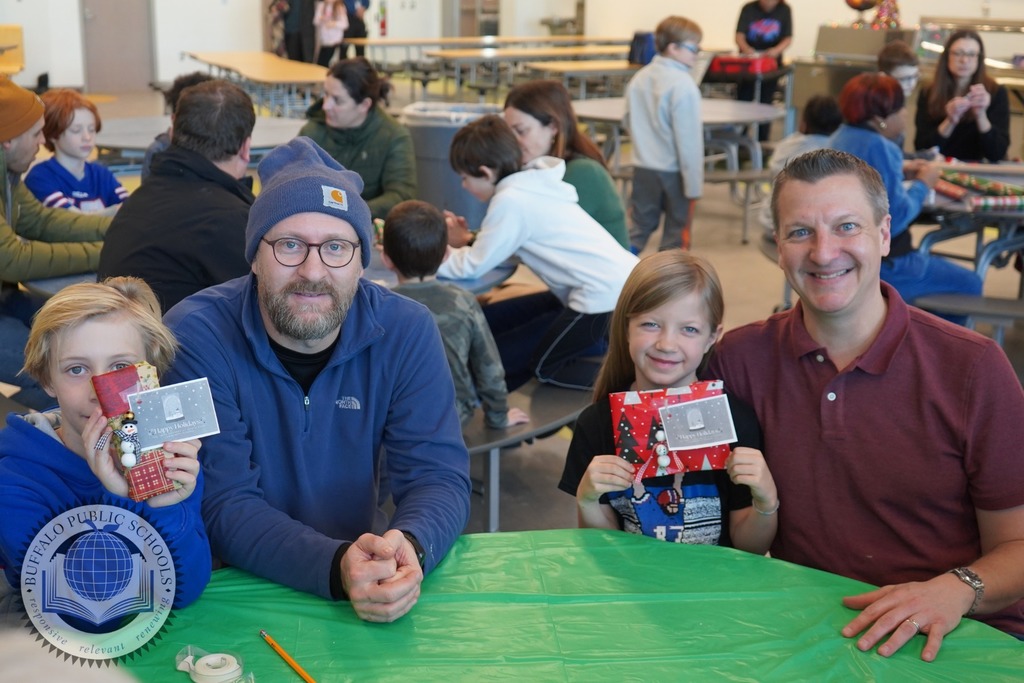 two parents with two students sitting at a table