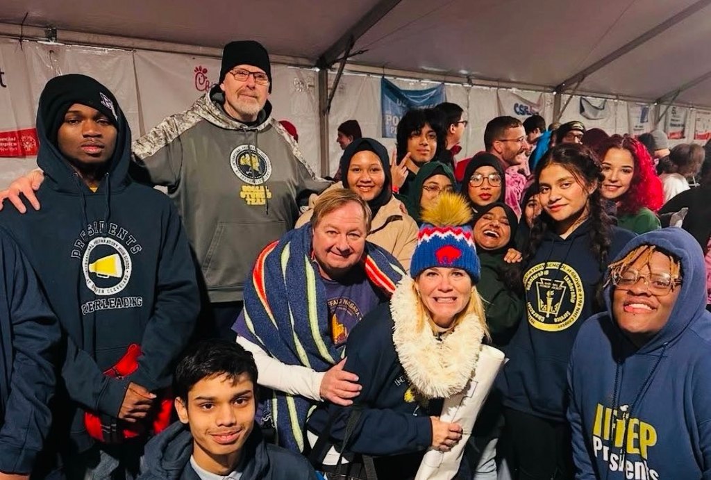 Group of iPrep Students with a polar bear mascot inside a warming hut.