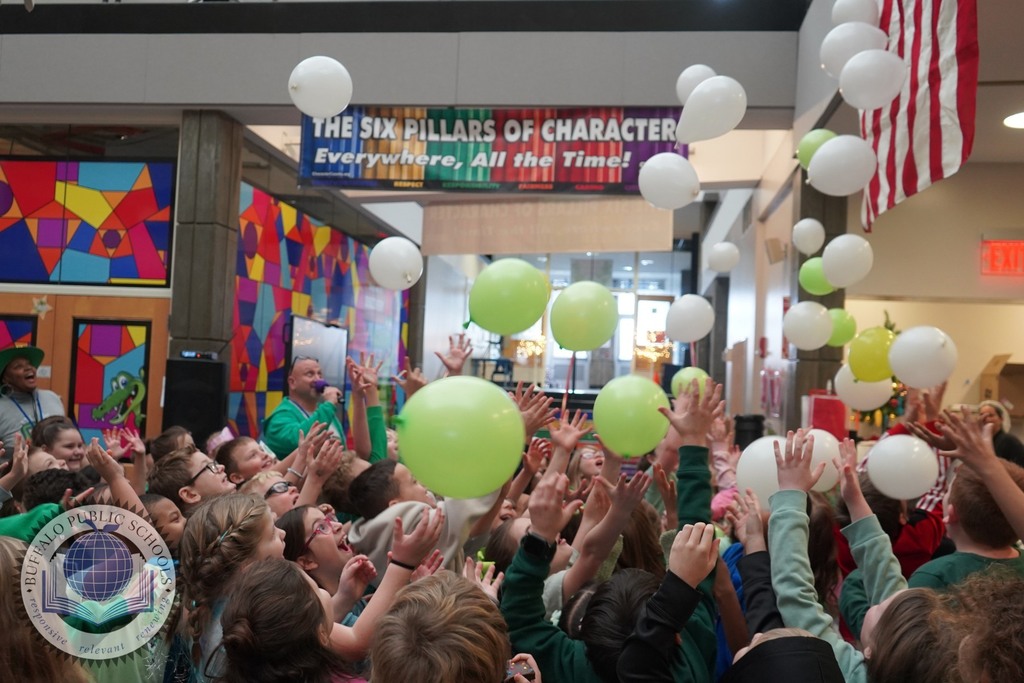 Group Students with hands up in air and towards balloons 