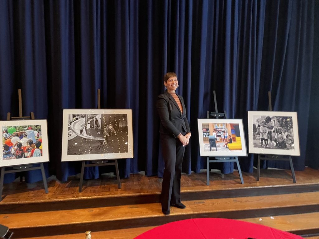 Director of Arts Michele Agosto standing with artwork