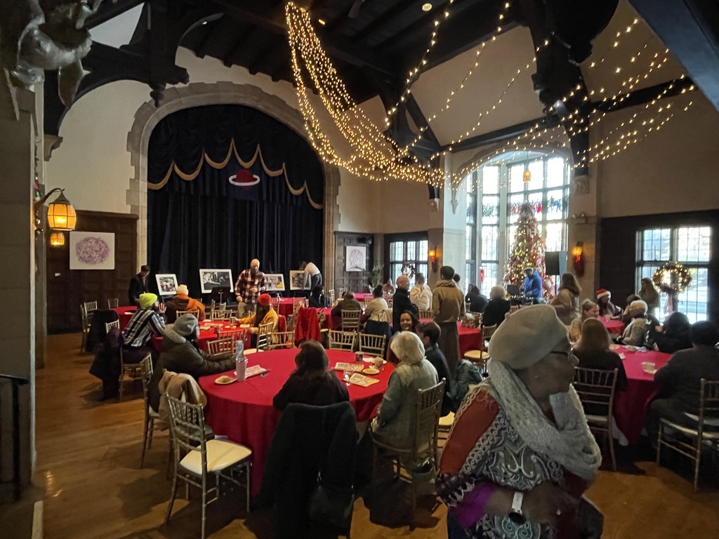 Director of Arts Michele Agosto speaking in a larger room.