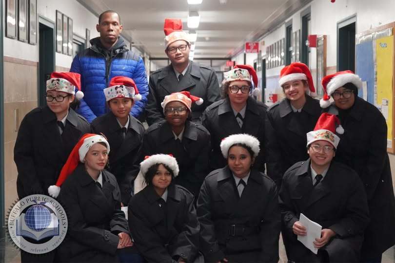 JROTC Students with Santa hats in a hallway 