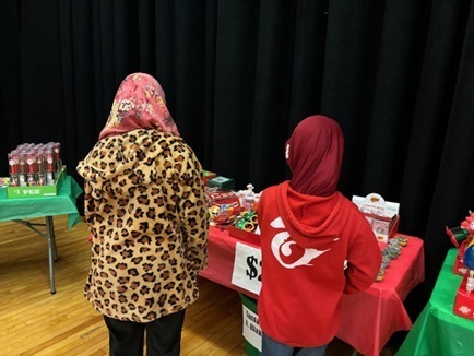 Kids at a table shopping in an auditorium