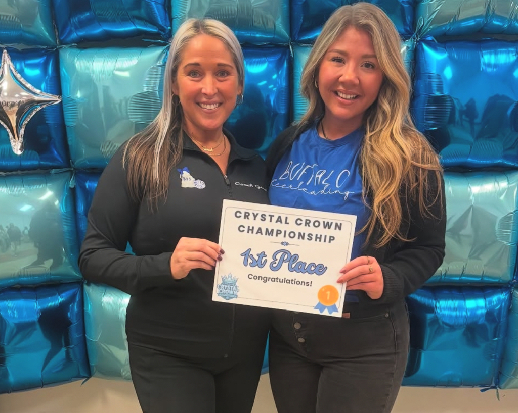 BPS Competitive Cheerleading  coaches holding a certificate.